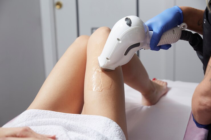 beautician-removing-hair-young-woman-s-leg-with-laser_101945-108
